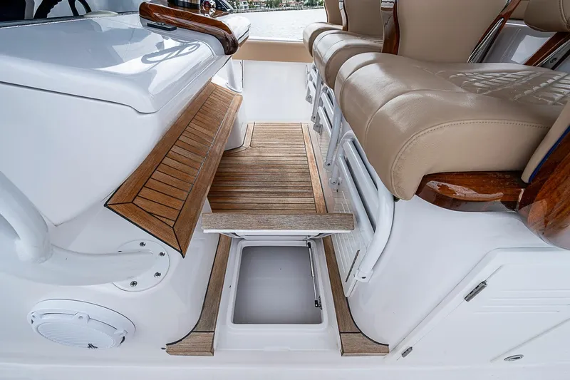 Slide: The Image of Luxurious seating and storage on 2024 Jupiter 43 boat, featuring elegant wood and leather finishes. - 51