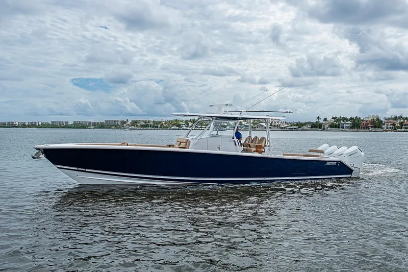 Slide: The Image of 2024 Jupiter 43 boat cruising on a calm waterway under a cloudy sky. - 8