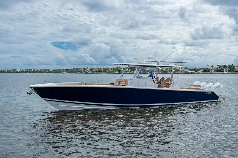 Slide: The Image of 2024 Jupiter 43 boat on calm water under cloudy sky. - 9