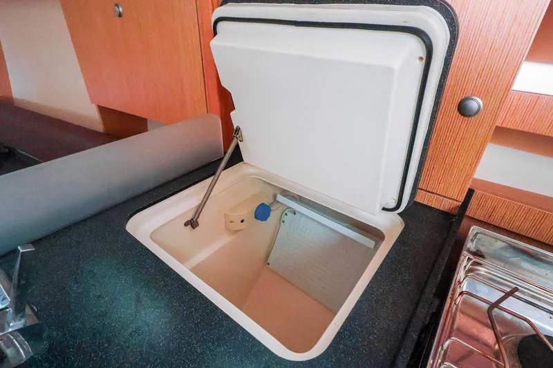 Slide: The Image of Interior view of a 2019 Hanse 315 yacht kitchen with open storage compartment. - 10