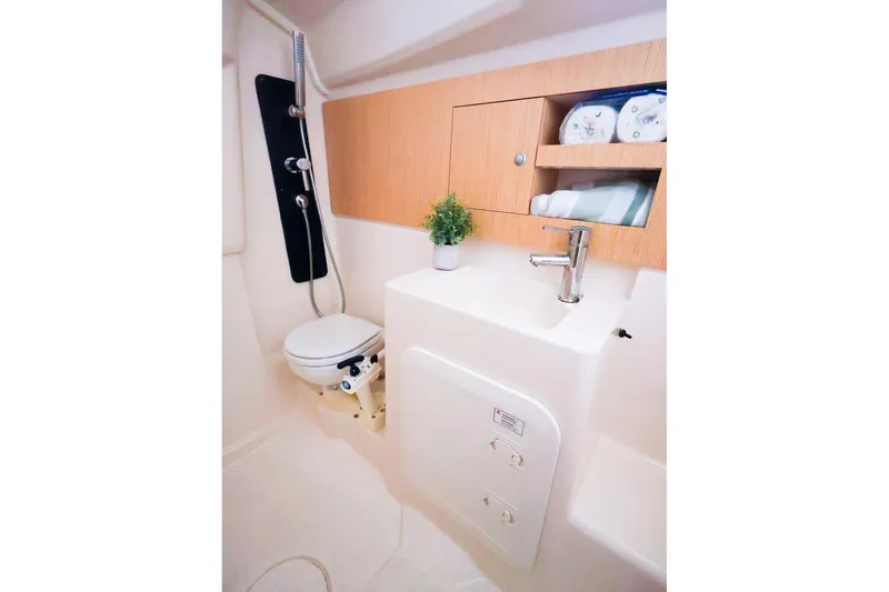 Slide: The Image of 2019 Hanse 315 yacht bathroom with modern fixtures, wooden cabinetry, and compact design. - 12
