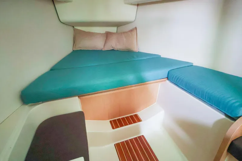 Slide: The Image of Cozy cabin interior of 2019 Hanse 315 yacht with teal cushions and wooden accents. - 15