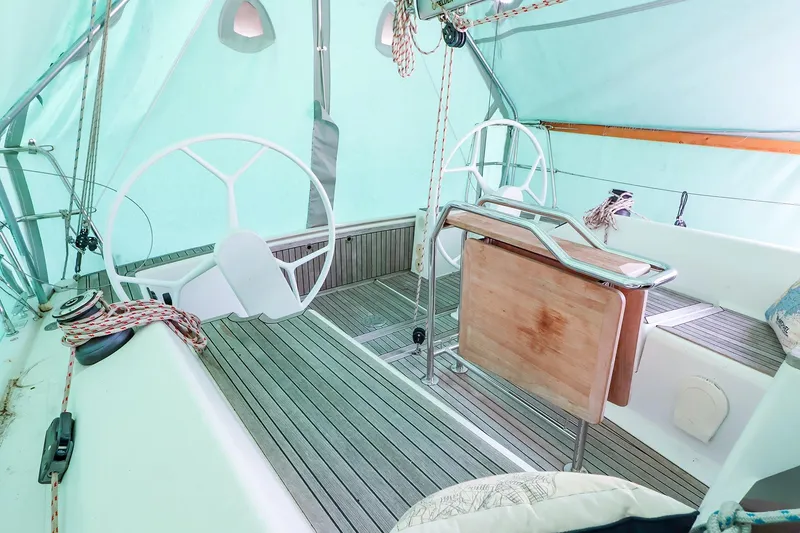 Slide: The Image of 2019 Hanse 315 yacht cockpit with dual steering wheels and teak flooring. - 18