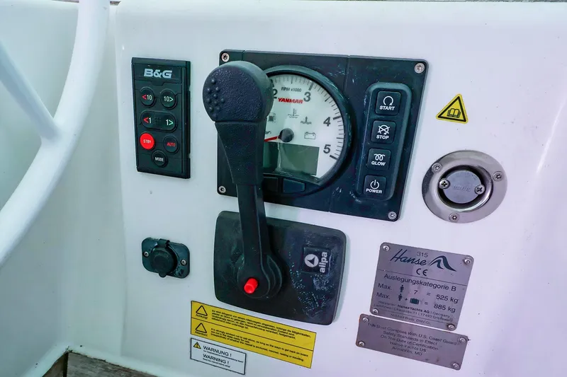 Slide: The Image of Control panel of a 2019 Hanse 315 yacht with various gauges and switches. - 19
