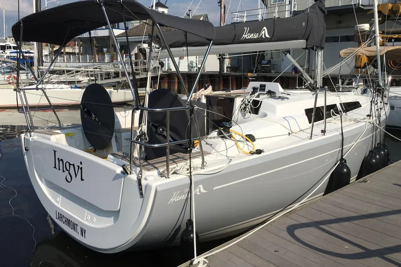 Slide: The Image of 2019 Hanse 315 sailboat docked at marina, featuring sleek design and modern rigging. - 2