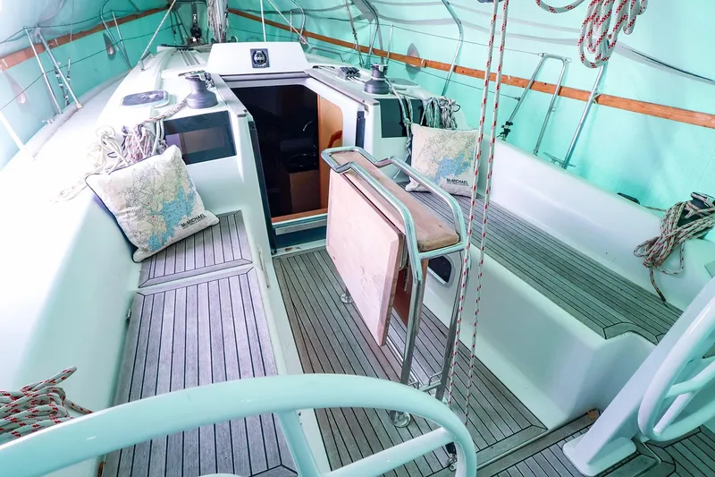 Slide: The Image of 2019 Hanse 315 sailboat cockpit with wooden flooring and nautical decor. - 20