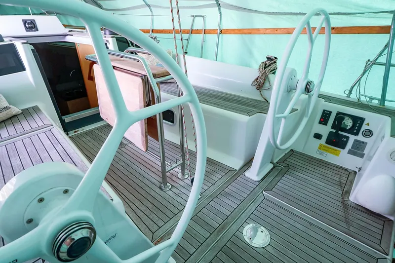 Slide: The Image of 2019 Hanse 315 yacht cockpit with dual steering wheels and teak flooring. - 21