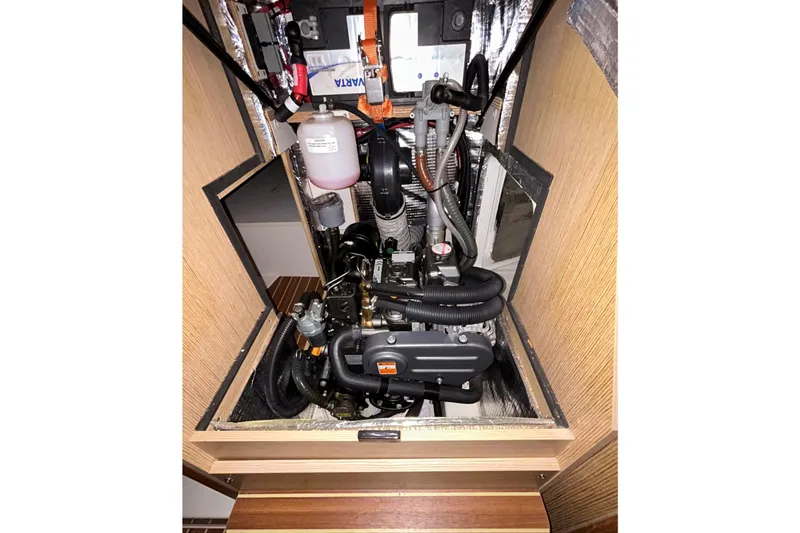 Slide: The Image of Engine compartment of a 2019 Hanse 315 sailboat, showcasing mechanical components. - 26