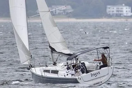 Slide: The Image of 2019 Hanse 315 sailboat navigating choppy waters near a coastal area. - 27