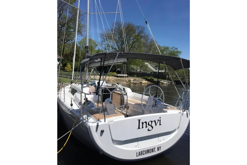 Slide: The Image of 2019 Hanse 315 sailboat docked, featuring a sleek design and spacious cockpit. - 3