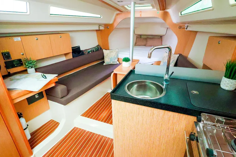 Slide: The Image of Interior of 2019 Hanse 315 yacht with modern kitchen and cozy seating area. - 4