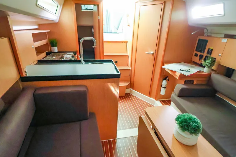 Slide: The Image of Interior of 2019 Hanse 315 yacht with modern kitchen and cozy seating area. - 7