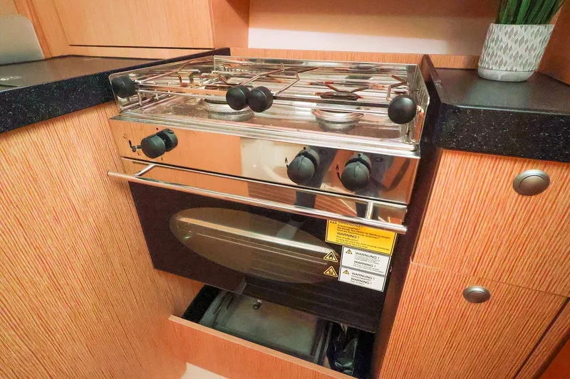 Slide: The Image of Compact kitchen stove and oven in a 2019 Hanse 315 yacht interior. - 9