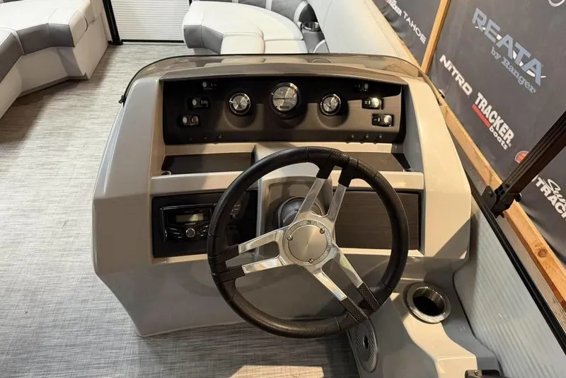 Slide: The Image of 2021 Bennington 20 LSB boat dashboard with steering wheel and control panel. - 10