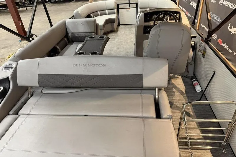 Slide: The Image of 2021 Bennington 20 LSB pontoon boat interior with plush seating and steering console. - 11