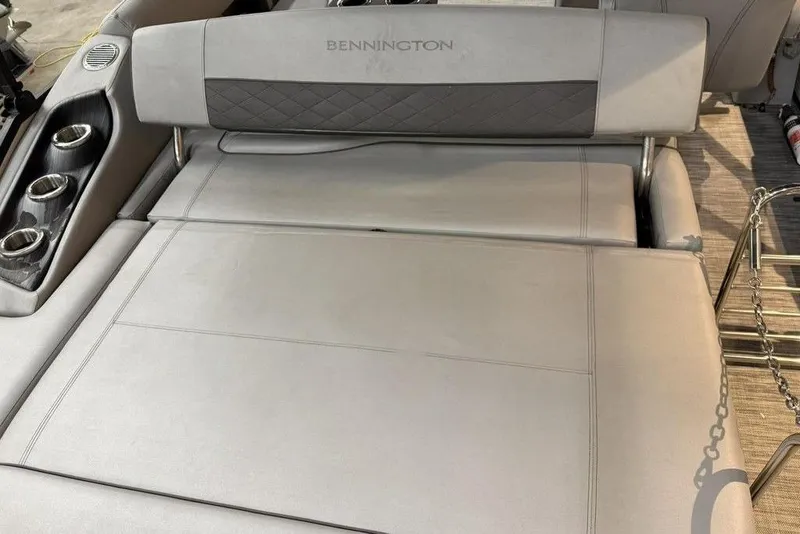 Slide: The Image of 2021 Bennington 20 LSB boat interior with gray seating and cup holders. - 13