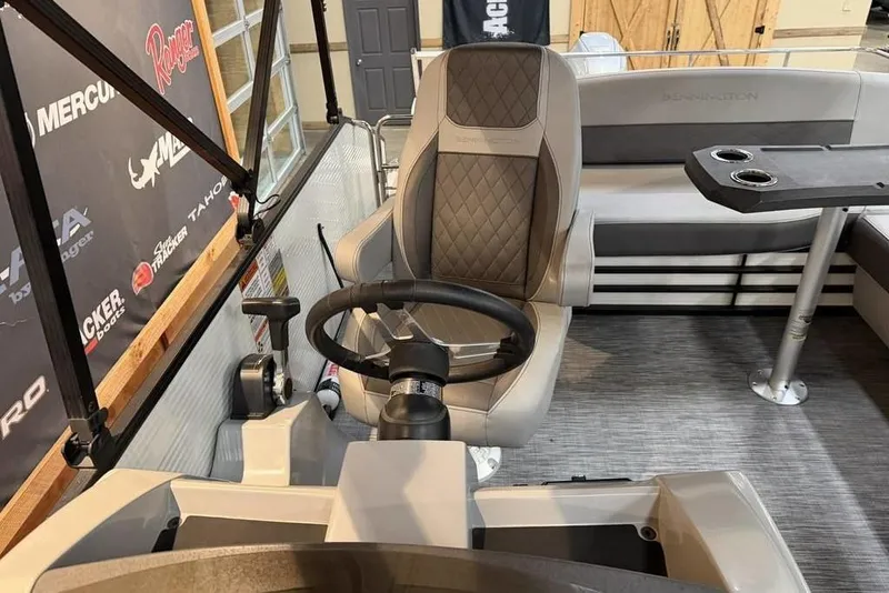 Slide: The Image of 2021 Bennington 20 LSB boat interior with steering wheel and seating area. - 6