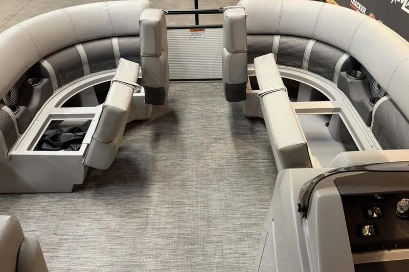 Slide: The Image of 2021 Bennington 20 LSB pontoon boat interior with plush seating and storage compartments. - 7