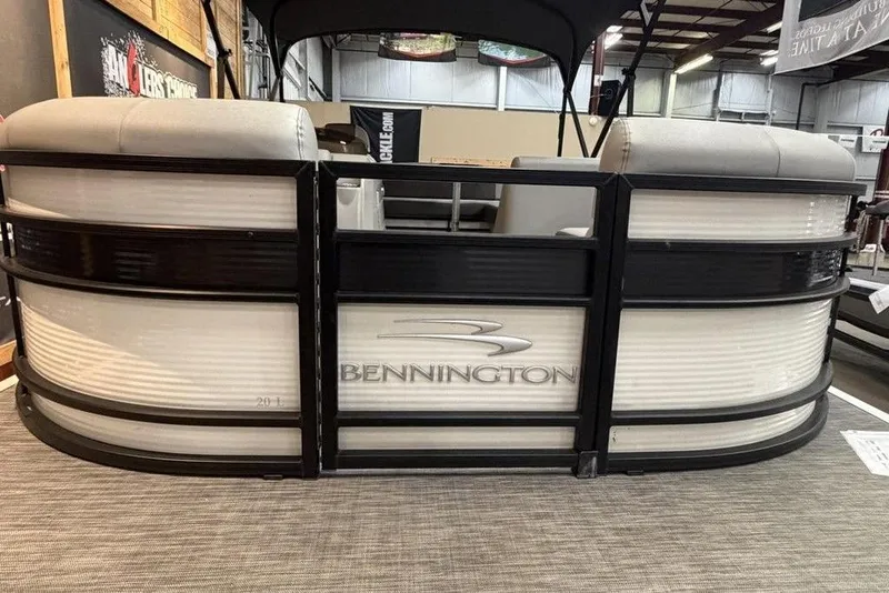 Slide: The Image of 2021 Bennington 20 LSB pontoon boat displayed indoors, showcasing sleek design and branding. - 9