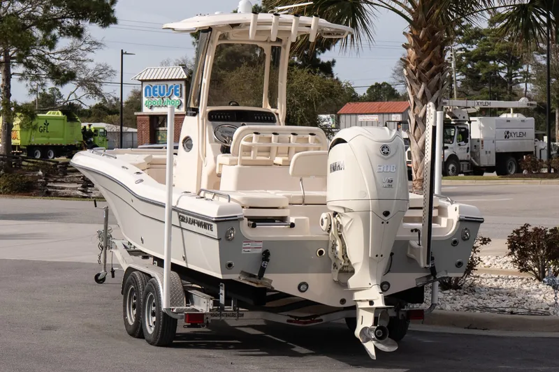 Slide: The Image of 2024 Grady-White 251 Coastal Explorer boat on trailer, parked outdoors. - 12