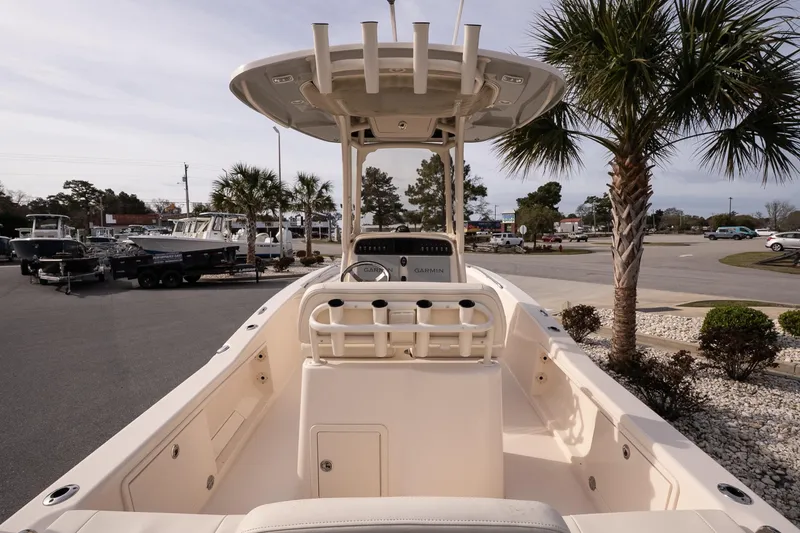 Slide: The Image of 2024 Grady-White 251 Coastal Explorer boat displayed outdoors with palm trees. - 15