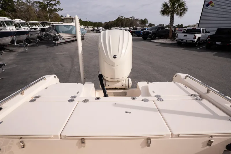 Slide: The Image of 2024 Grady-White 251 Coastal Explorer boat with outboard motor in a marina setting. - 18