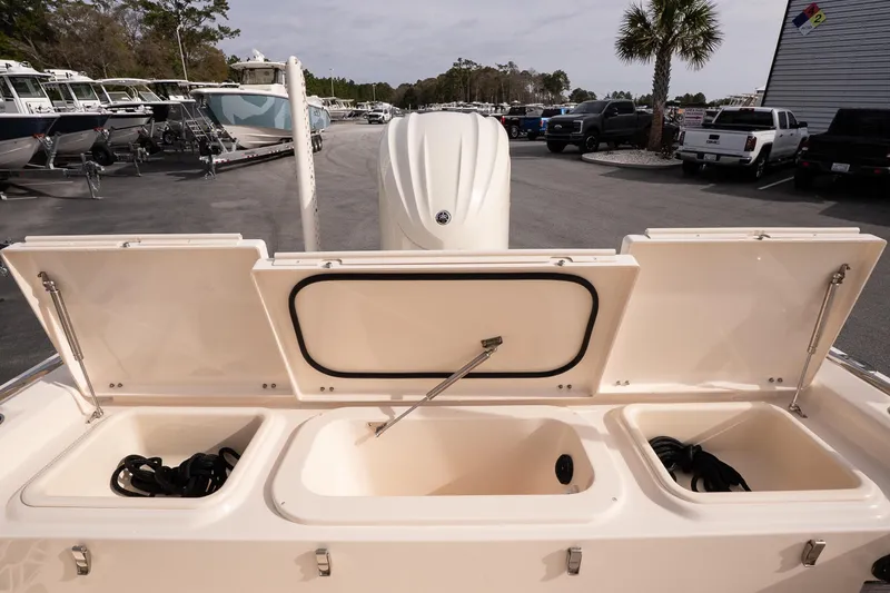 Slide: The Image of 2024 Grady-White 251 Coastal Explorer boat storage compartments open at marina. - 19