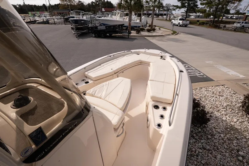 Slide: The Image of 2024 Grady-White 251 Coastal Explorer boat with spacious seating at a marina. - 25