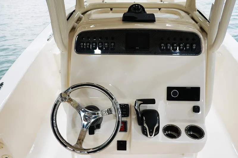 Slide: The Image of Manufacturer Provided Image: 2024 Grady-White 251 Coastal Explorer boat helm with steering wheel and control panel. - 7