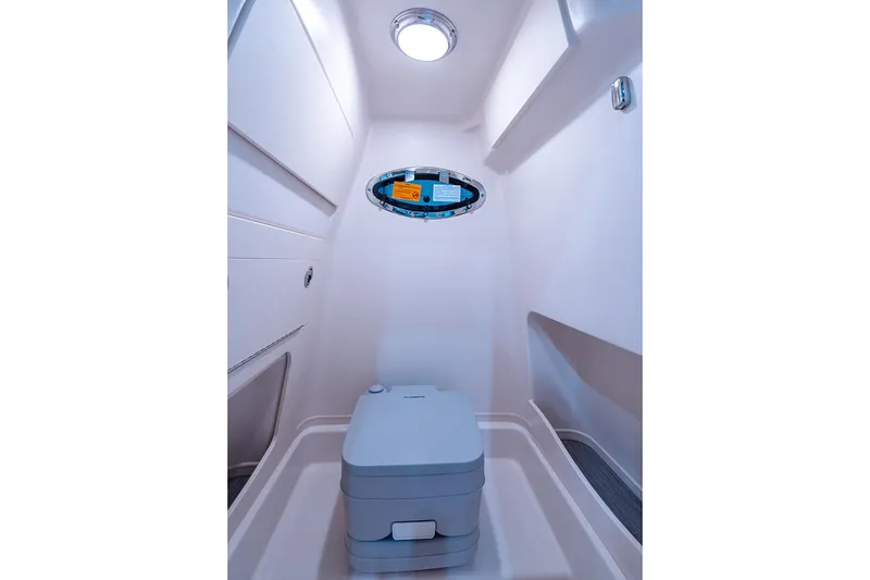 Slide: The Image of Manufacturer Provided Image: 2024 Grady-White 251 Coastal Explorer boat interior with compact marine toilet. - 9