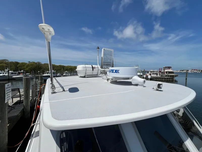 Slide: The Image of 2022 Wesmac 38 boat docked, featuring radar and antennas on the roof. - 11