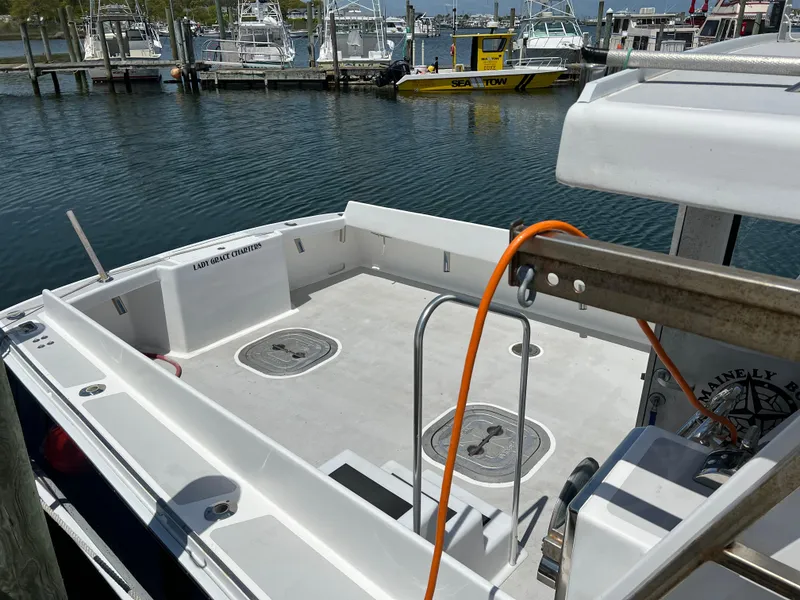 Slide: The Image of Wesmac 38 boat deck, 2022 model, docked at marina with clear water view. - 17