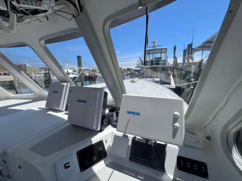 Slide: The Image of Wesmac 38 boat interior with navigation equipment, 2022 model, docked at a marina. - 22