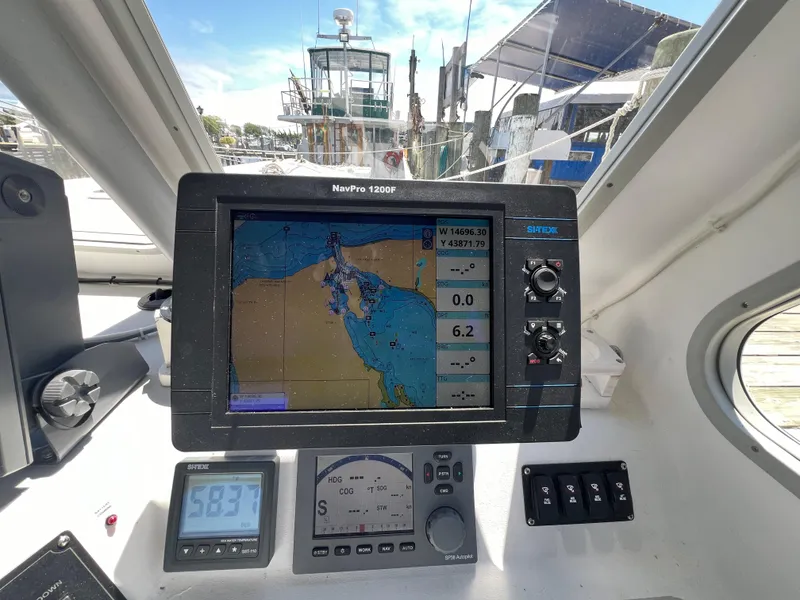Slide: The Image of Navigation system on 2022 Wesmac 38 boat, displaying nautical map and controls. - 23