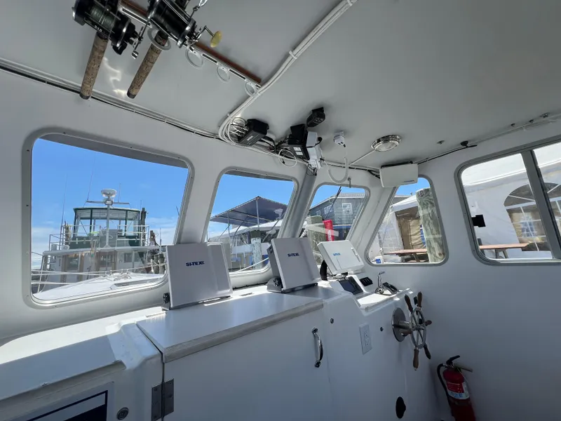 Slide: The Image of Interior of 2022 Wesmac 38 boat with navigation equipment and windows. - 27