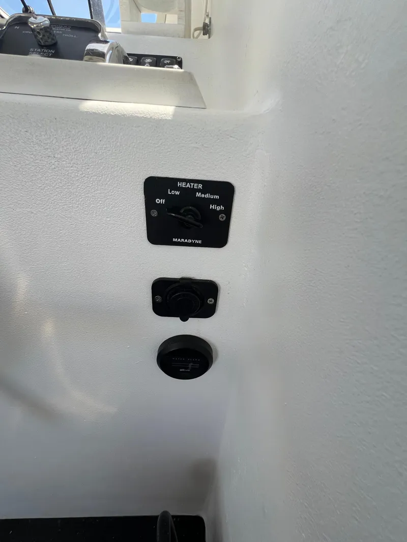Slide: The Image of Control panel on a 2022 Wesmac 38 boat, featuring heater settings. - 28