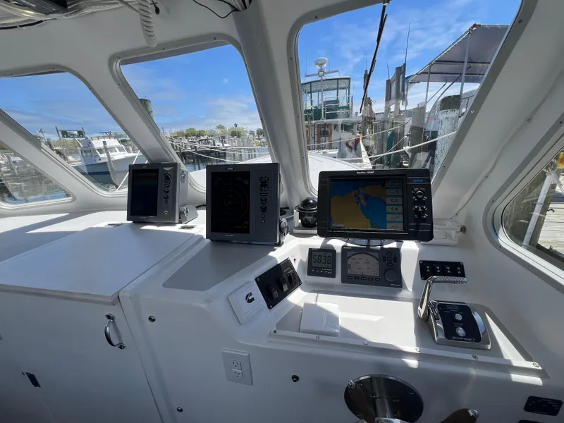 Slide: The Image of Helm of 2022 Wesmac 38 boat with navigation equipment and controls. - 3