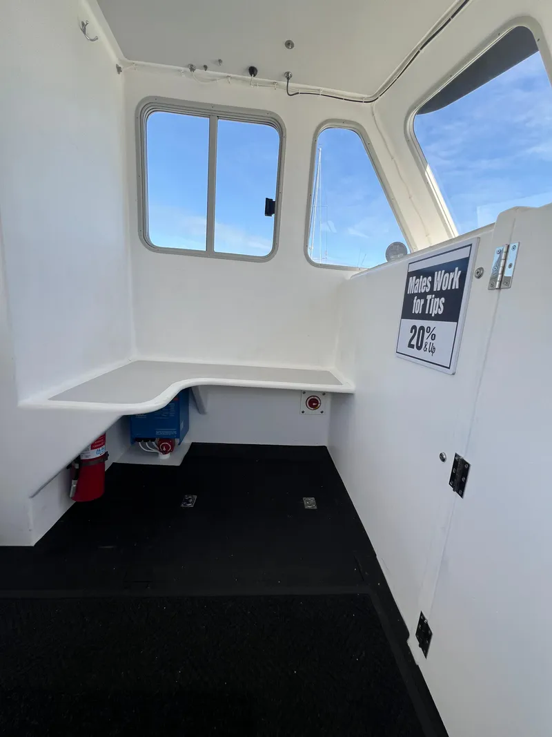 Slide: The Image of Interior of 2022 Wesmac 38 boat with seating and tip sign. - 30