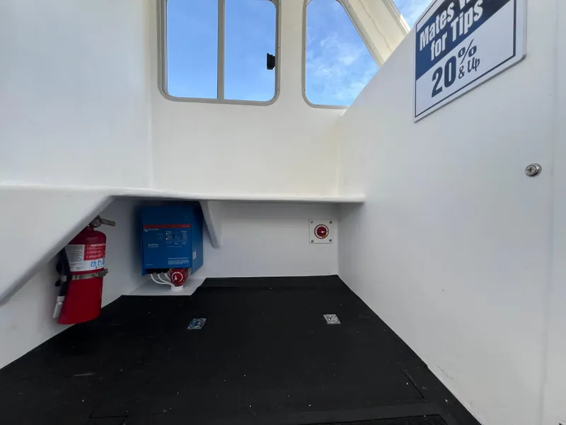 Slide: The Image of Interior of 2022 Wesmac 38 boat with fire extinguisher and tip sign. - 31