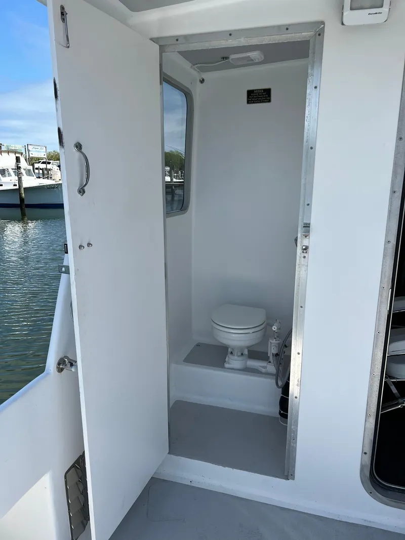 Slide: The Image of 2022 Wesmac 38 boat interior with compact bathroom and toilet. - 35