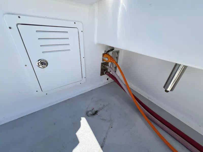 Slide: The Image of 2022 Wesmac 38 boat interior with cables and storage compartment. - 37