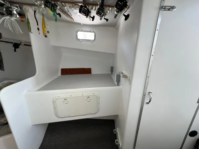 Slide: The Image of Interior of 2022 Wesmac 38 boat with fishing rods and storage area. - 42