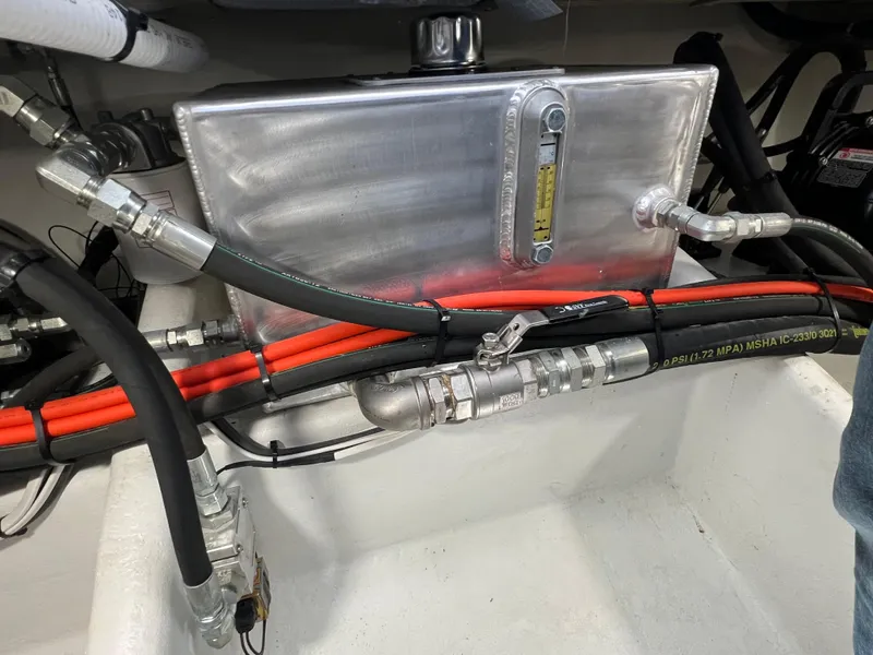 Slide: The Image of Engine compartment of a 2022 Wesmac 38 with hydraulic hoses and metal tank. - 45