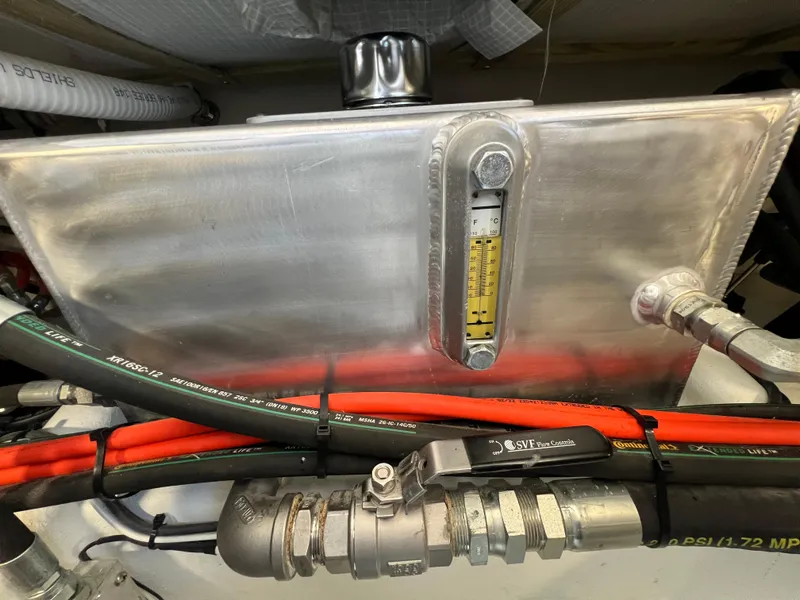 Slide: The Image of Engine compartment of 2022 Wesmac 38 with fuel tank and hoses. - 46