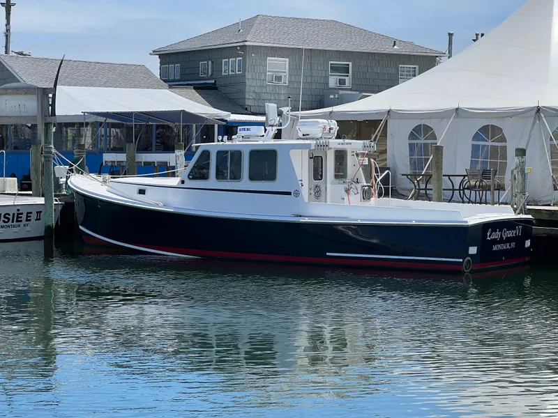 Slide: The Image of 2022 Wesmac 38 boat docked near waterfront buildings and tents. - 5