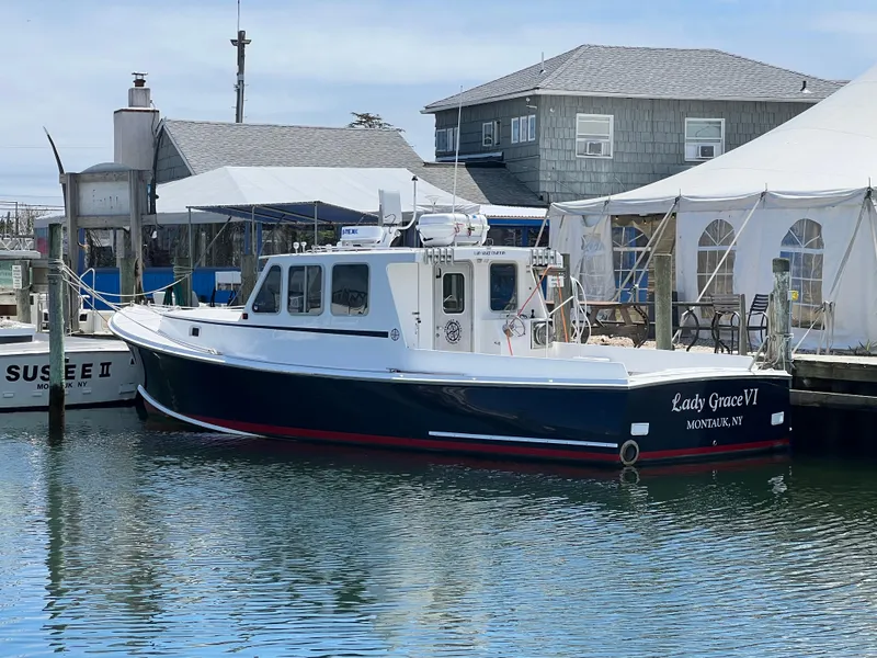 Slide: The Image of Wesmac 38 boat, 2022 model, docked near waterfront buildings and tents. - 6