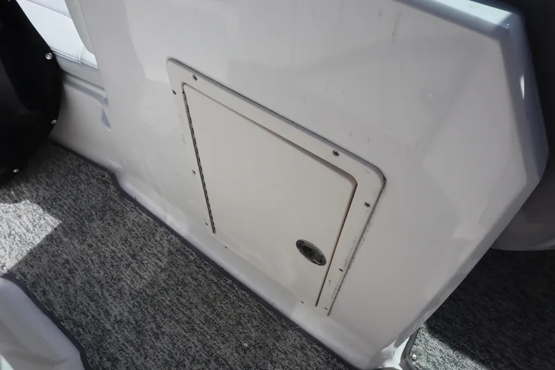 Slide: The Image of 2017 Chaparral 21 H2O Sport boat interior storage compartment with carpeted flooring. - 13