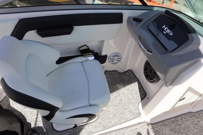 Slide: The Image of 2017 Chaparral 21 H2O Sport boat interior with white seating and dashboard details. - 19