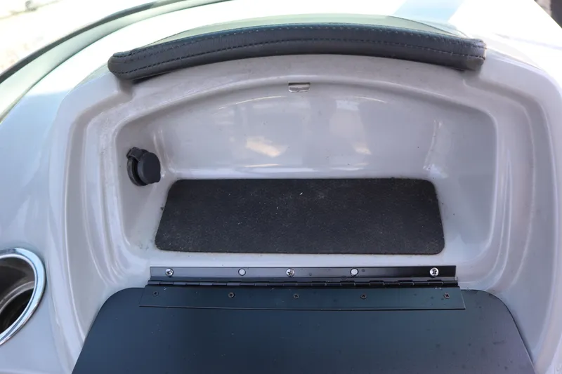Slide: The Image of 2017 Chaparral 21 H2O Sport glove compartment with cup holder and black mat. - 21