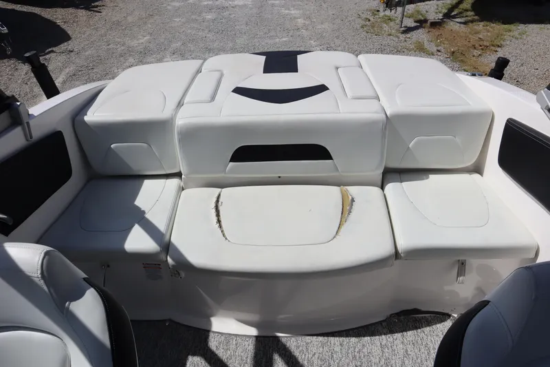 Slide: The Image of 2017 Chaparral 21 H2O Sport boat interior with white seating and visible wear. - 23